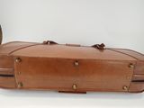 an image of a brown suitcase sitting on top of a white table