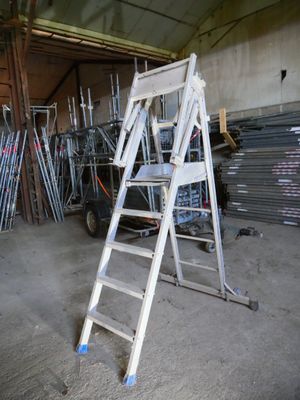 a ladder that is leaning against a wall in a garage