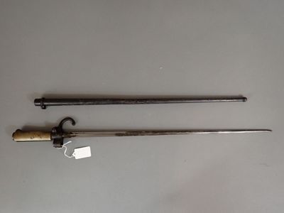 pair of old swords on a table with tags attached to them