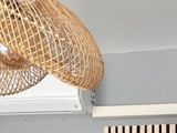 a rattan hanging from the ceiling above a radiator