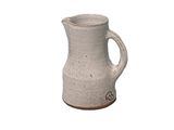 a white pitcher that is sitting on a table