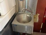 a sink in the corner of a small room