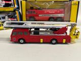 a red fire truck with a crane on top of it