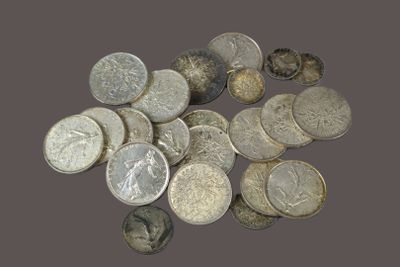 a pile of silver coins sitting on a table