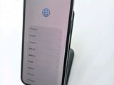 a phone that is sitting on top of a stand