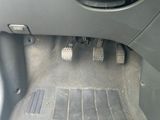 a close up of a car ' s foot pedals in the floor