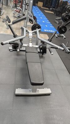 an image of a gym room with a bench and weights