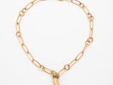 un bracelet en chaîne d'or orné d'un pendentif en forme de croissant