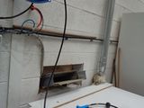 a refrigerator and a freezer in a room with a lot of wires