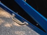 a close up of a metal handle on a blue car