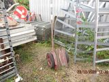 a pile of junk in a yard with a ladder and a pile of other junk