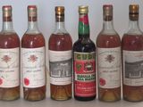several bottles of wine are lined up on a table