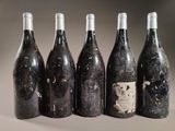 six bottles of wine are lined up in a row on a table