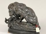 an image of a statue of a lion on a rock