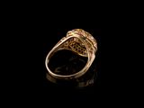 a close up of a gold ring on a black surface