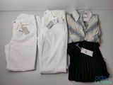 two pairs of white pants and a shirt are on a shelf