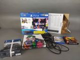 the contents of a ps4 console, including a game case, a controller, and a charger