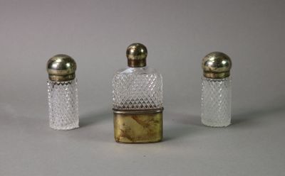 three small glass bottles with gold caps and a small glass bottle with a gold top