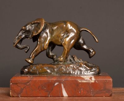 bronze statue of an elephant on a marble base on a table