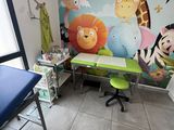 a room with a desk, chair, and wall mural in it