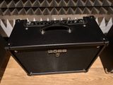 a black amp sitting on a table in front of a speaker