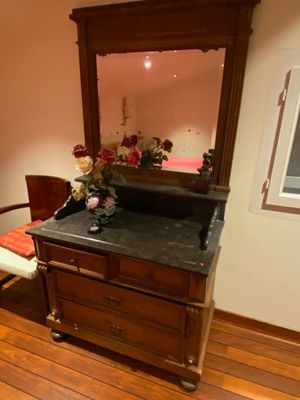 a dresser with a mirror on top of it in a room