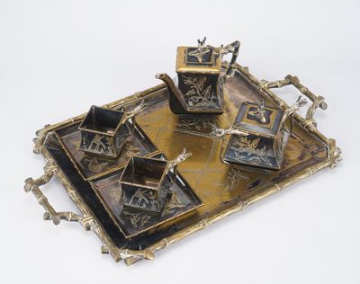 a brass tray with a set of four different items on it