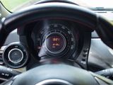 a close up of a steering wheel with a clock on it