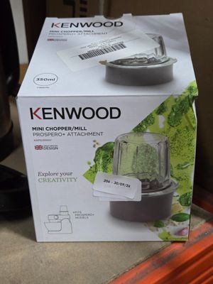 packaging of a blender sitting on top of a counter next to a coffee pot