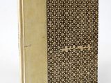 an old book with a brown cover and a pattern on it