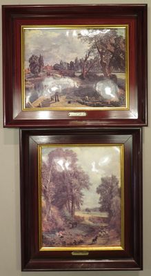 two paintings hanging on the wall of a room