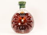 a bottle of brandy sitting on a white surface
