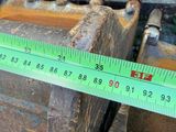 someone is measuring the length of a piece of wood with a ruler