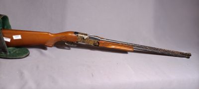 a toy gun with a green hat on it
