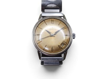 a close up of a watch on a white surface with a white background