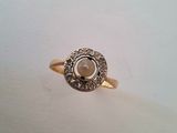 a close up of a gold ring with a stone in the center