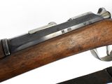 an old rifle with a wooden frame and a metal handle