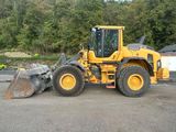 a picture of a yellow construction vehicle parked in a parking lot