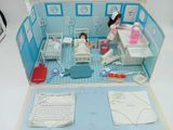 a doll house with a doll in the middle of it