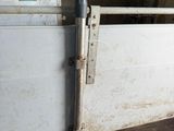 a white door with a metal latch on it in a building
