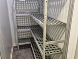 a metal shelf in the corner of a room
