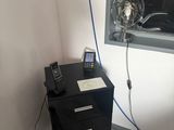 a black filing cabinet with a phone on top of it