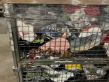 a metal cart with many items in it in a warehouse
