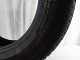 tire on a white surface with a white curtain in the background