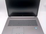 an open laptop computer sitting on top of a white table