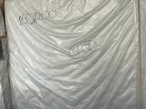 many mattresses that are wrapped up in a room