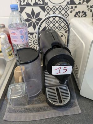 a coffee maker sitting on top of a counter next to a sink