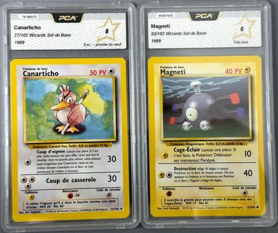 two pokemon cards in plastic cases sitting on top of a table