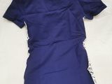 a close up of a shirt on a bed with a white sheet