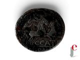 an old coin with a horse on it sitting on top of a white surface